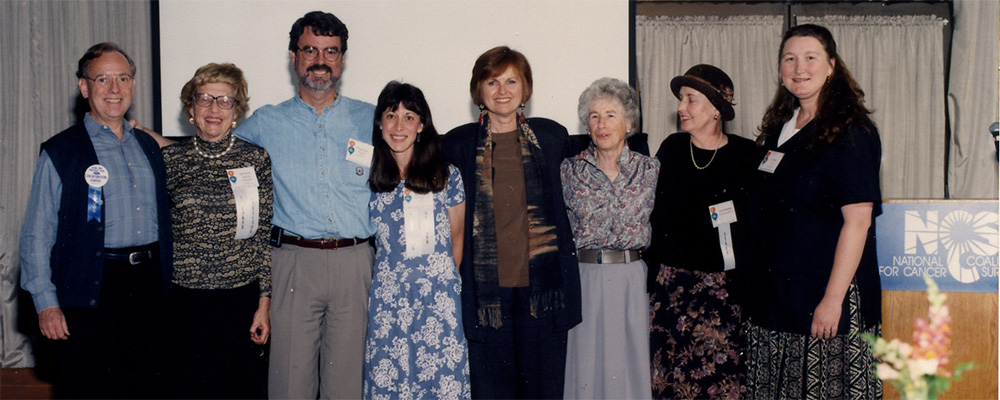 A photo of eight co-founding members of NCCS at the 1996 NCCS National Assembly.