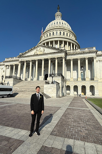 Brandon Hertzendorf in front of the U.S. Capitol building
