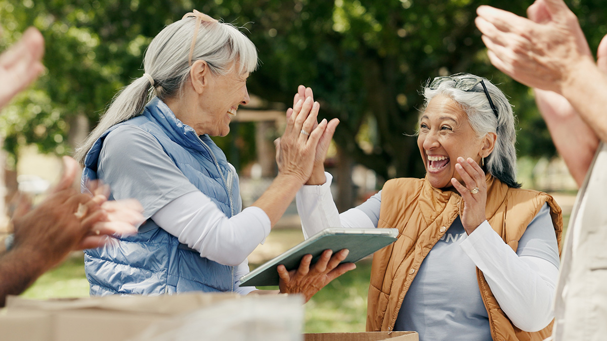 Two women cheering at a charity event