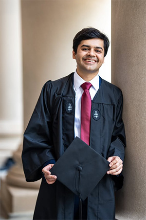 Eshan Vishwakarma holding graduation cap