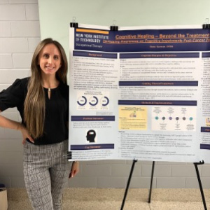 Picture of Gena presenting a poster on a table while demonstrating various Occupational Therapy techniques and tools at an event.