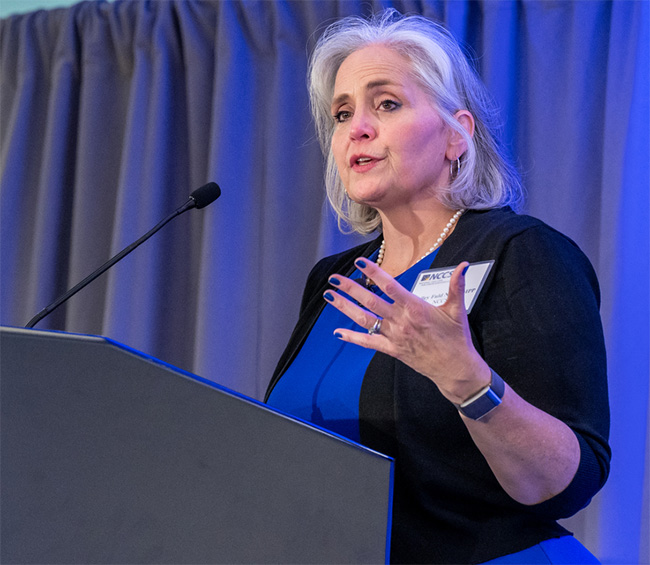 Shelley Fuld Nasso speaking at a podium