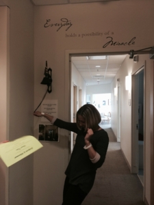 Young, female cancer survivor, Sarah Cohn rings the bell victoriously after completing cancer treatment.