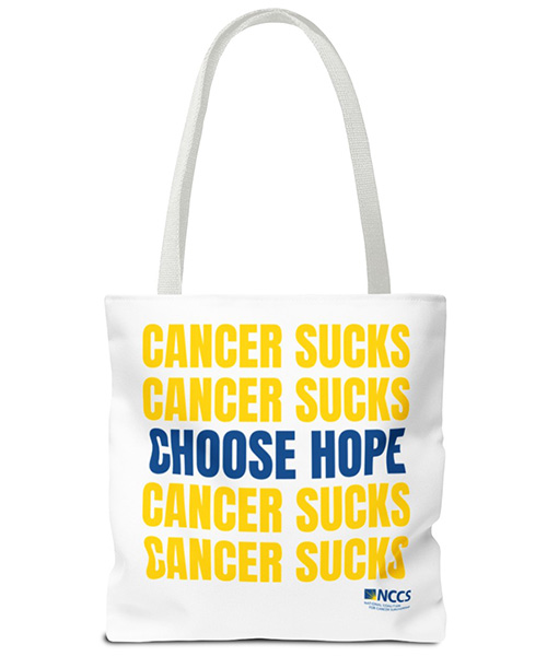 NCCS-branded tote bag reading "Cancer Sucks, Choose Hope".