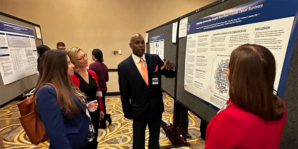 Photo of Dottington Fullwood presenting research at a conference.