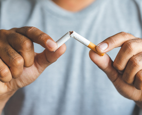 Man breaking cigarette
