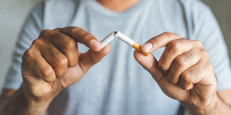 Man breaking cigarette